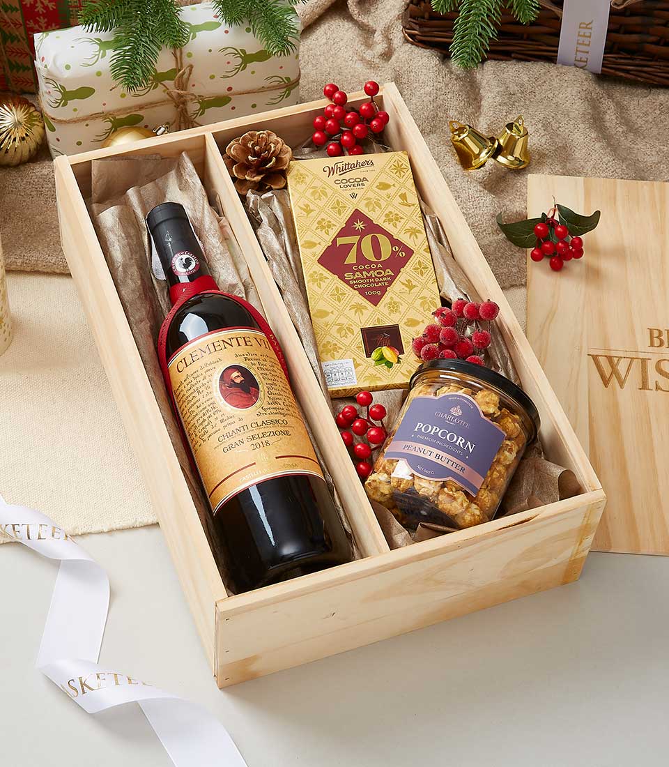 Premium red wine and dark chocolate gift set in wooden crate with artisan treats