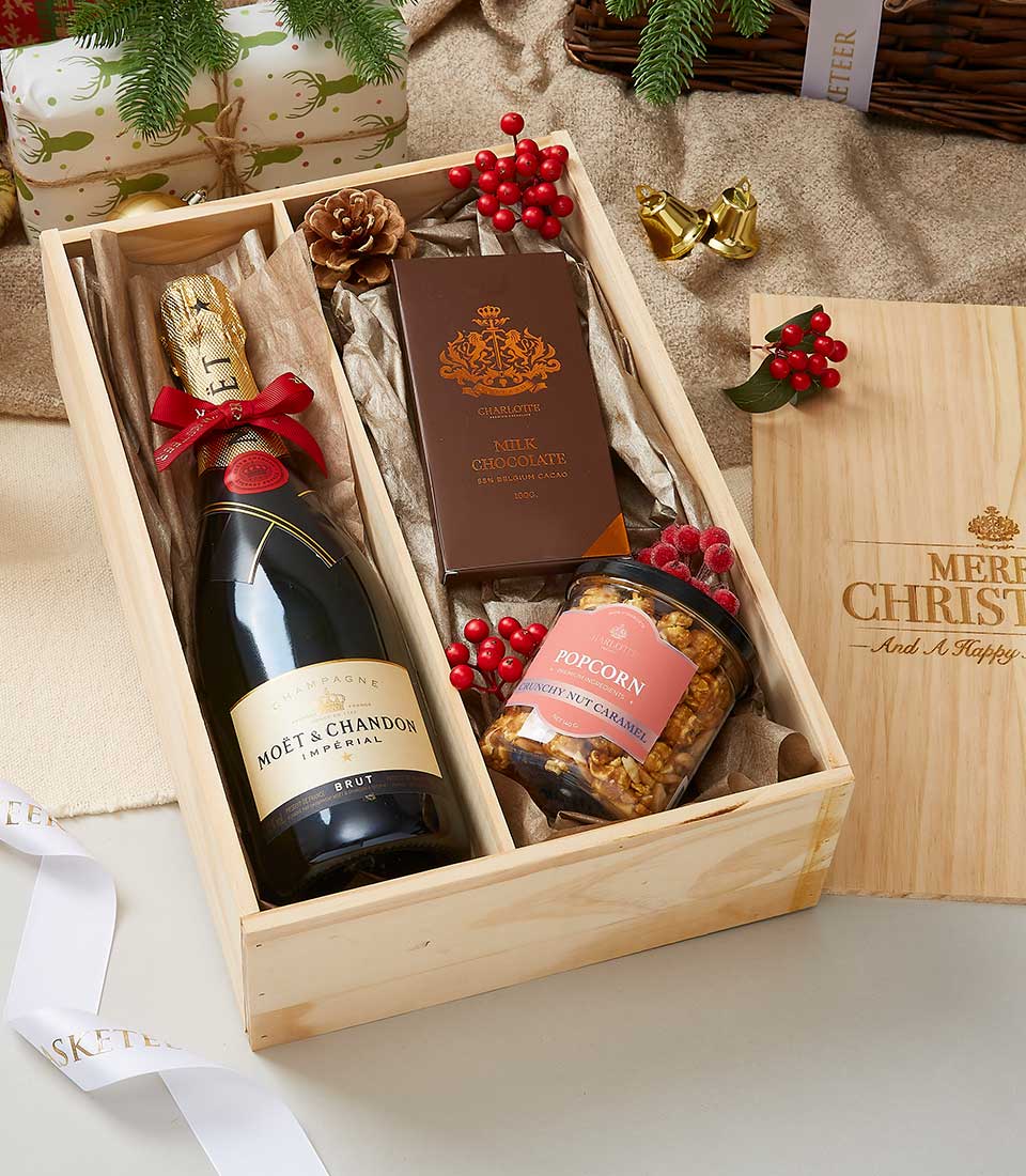 Champagne, chocolate and caramel popcorn luxury gift hamper in wooden box with red berry accents