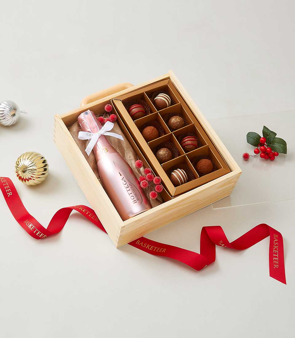 Pink sparkling wine and chocolate truffles luxury gift set in wooden box with red ribbon