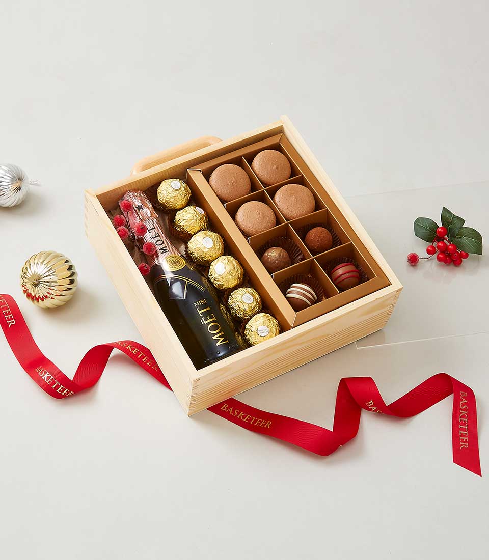 Premium wine gift box with Moët champagne, Ferrero Rocher, macarons, and chocolate truffles in wooden presentation case