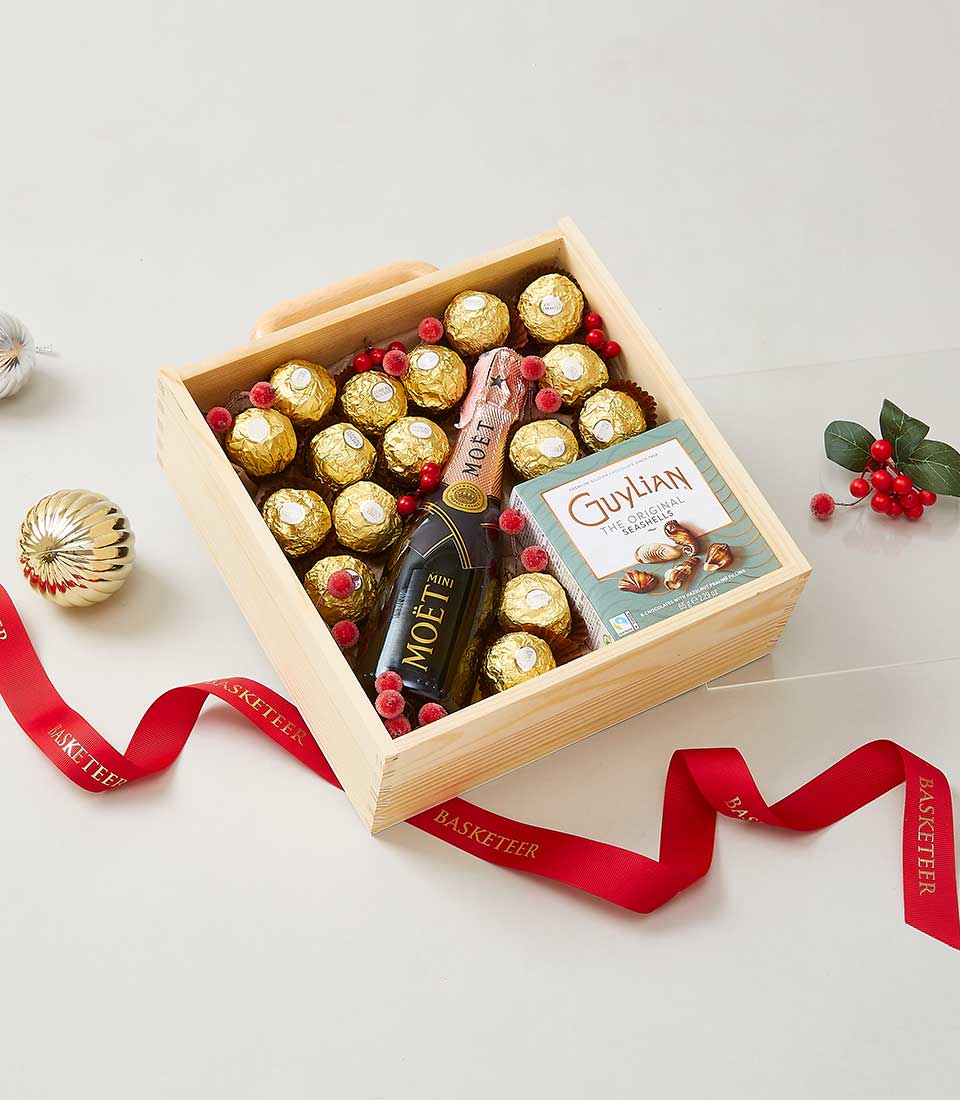 Ferrero chocolates and champagne gift box with gold-foil treats and red berry accents