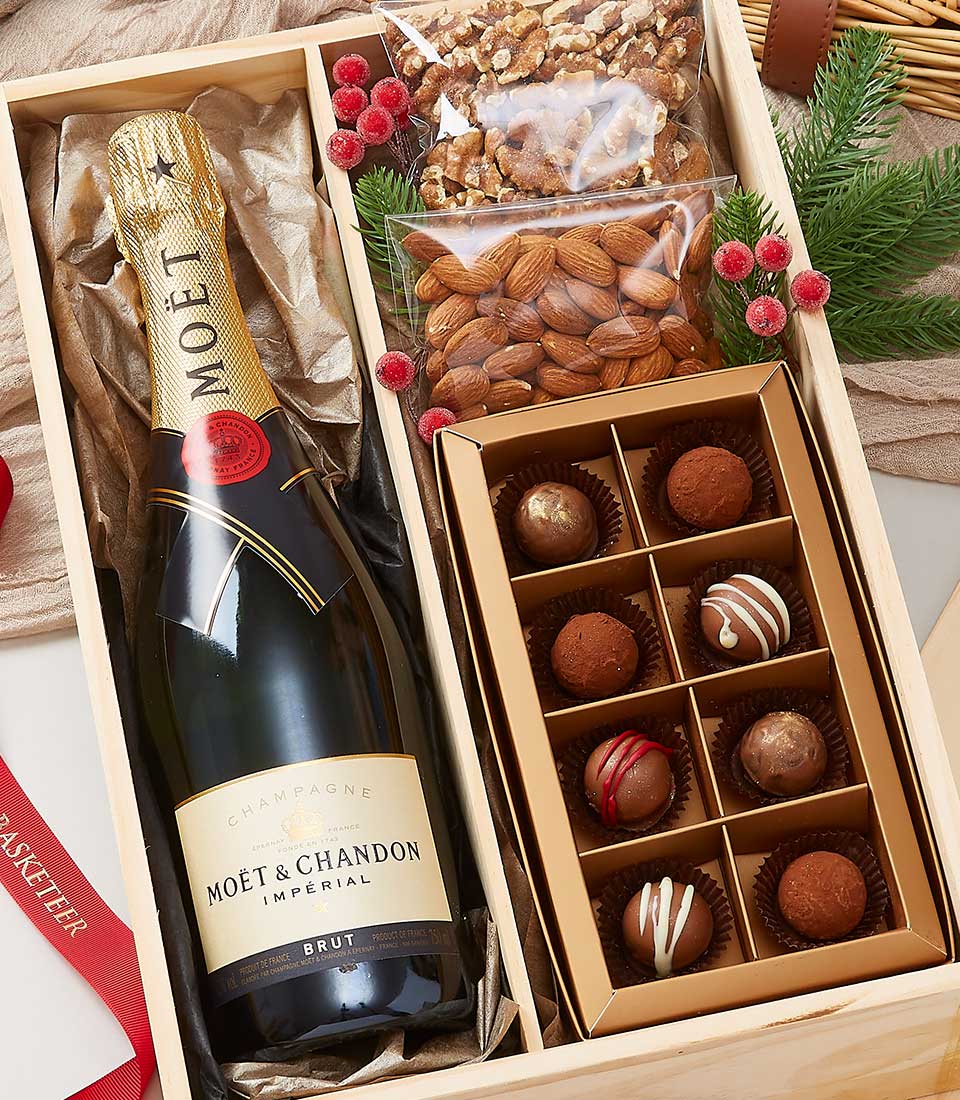 Premium champagne, chocolate truffles, and roasted nuts in luxe wooden gift crate