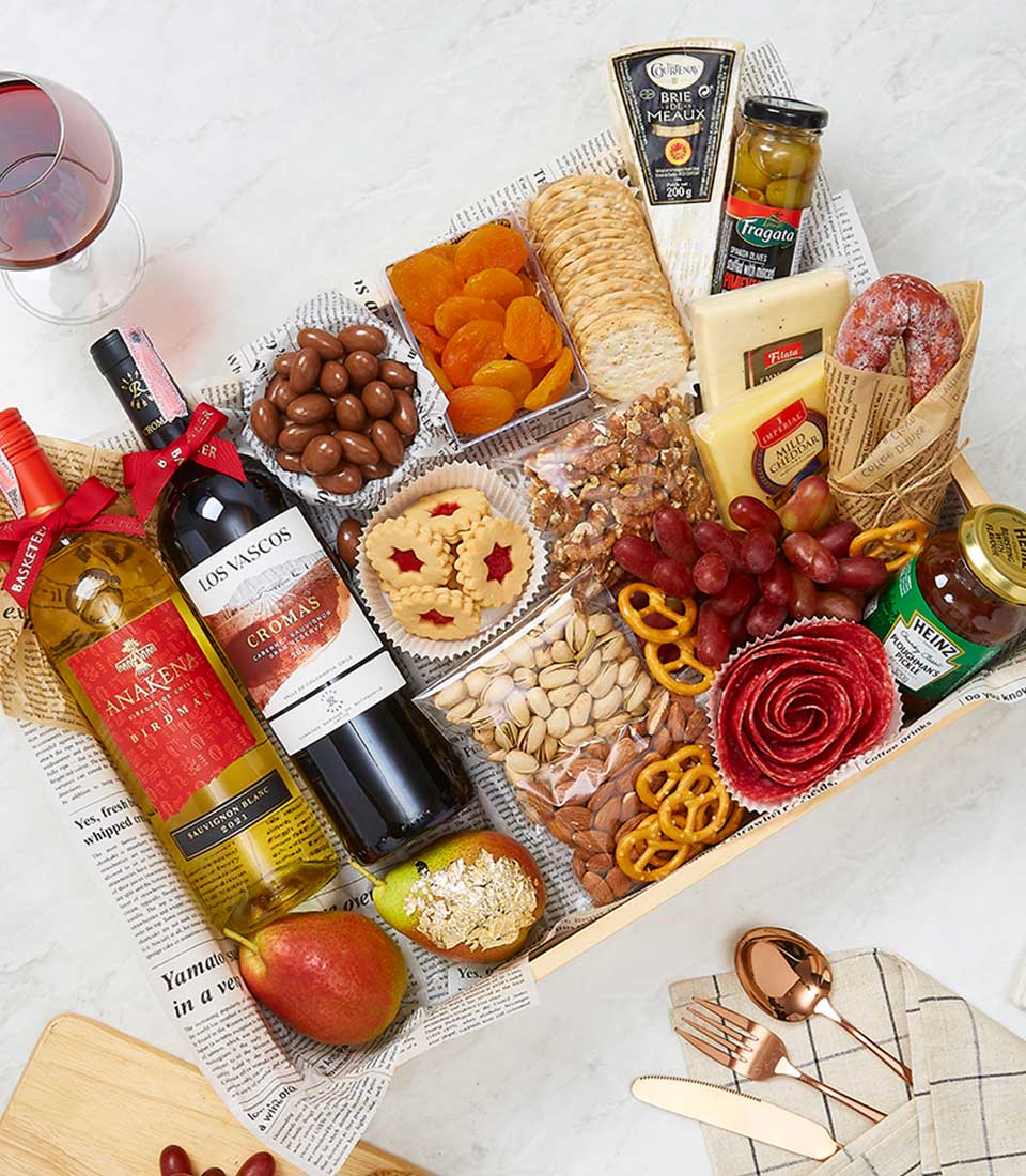 Premium wine and cheese gift hamper with red and white wines, artisan cheeses, charcuterie, and gourmet accompaniments