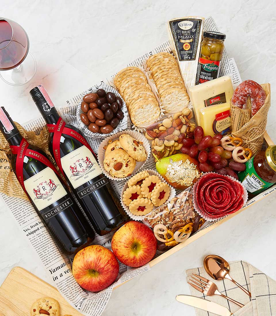 Premium gourmet gift hamper with two red wines, artisan cheeses, salami, crackers, and festive treats