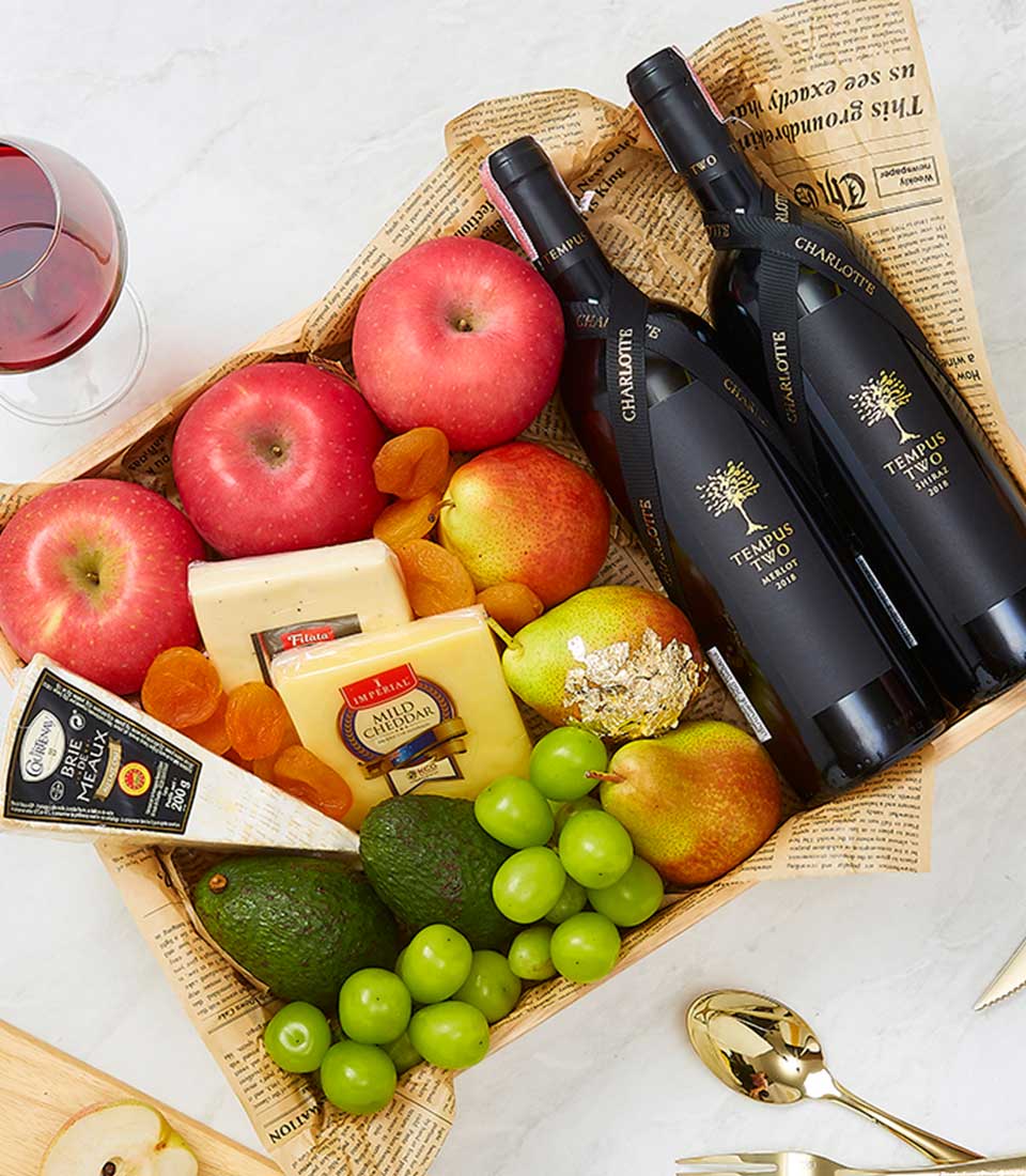 Premium wine gift basket with red Tempus Two wines, artisan cheeses, fresh fruit, and gourmet pairings in wooden tray