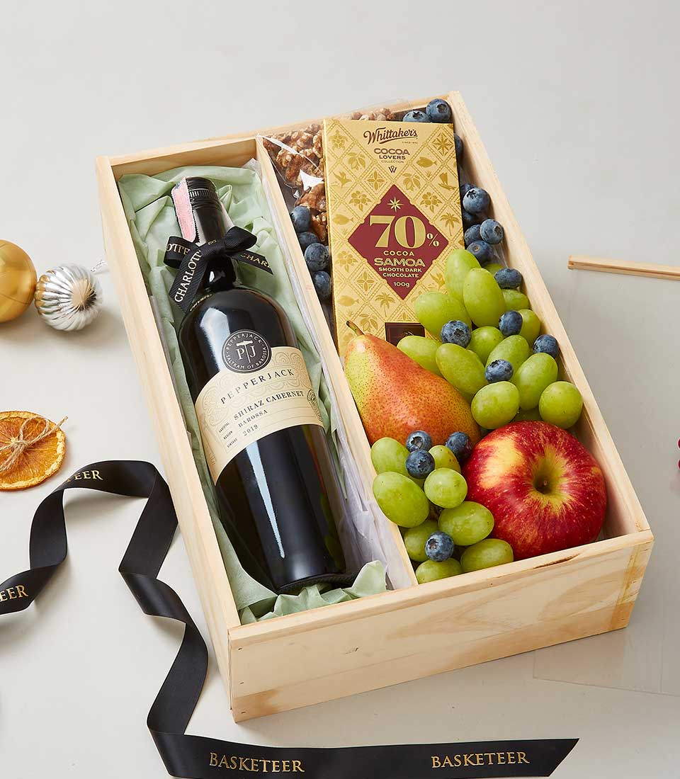 Premium red wine, dark chocolate, and fresh fruit gift hamper in wooden box with luxury presentation