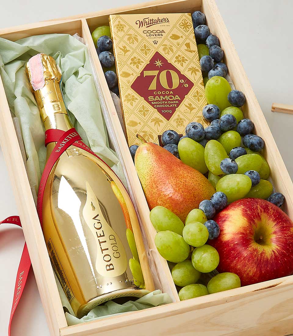 Bottega Gold Prosecco with fresh fruit, dark chocolate, and blueberries in wooden gift box