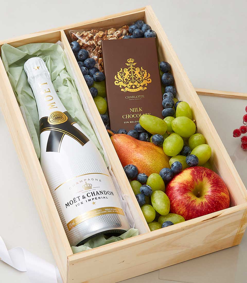 Moët & Chandon champagne gift hamper with fresh fruits, chocolate, and walnuts in wooden box