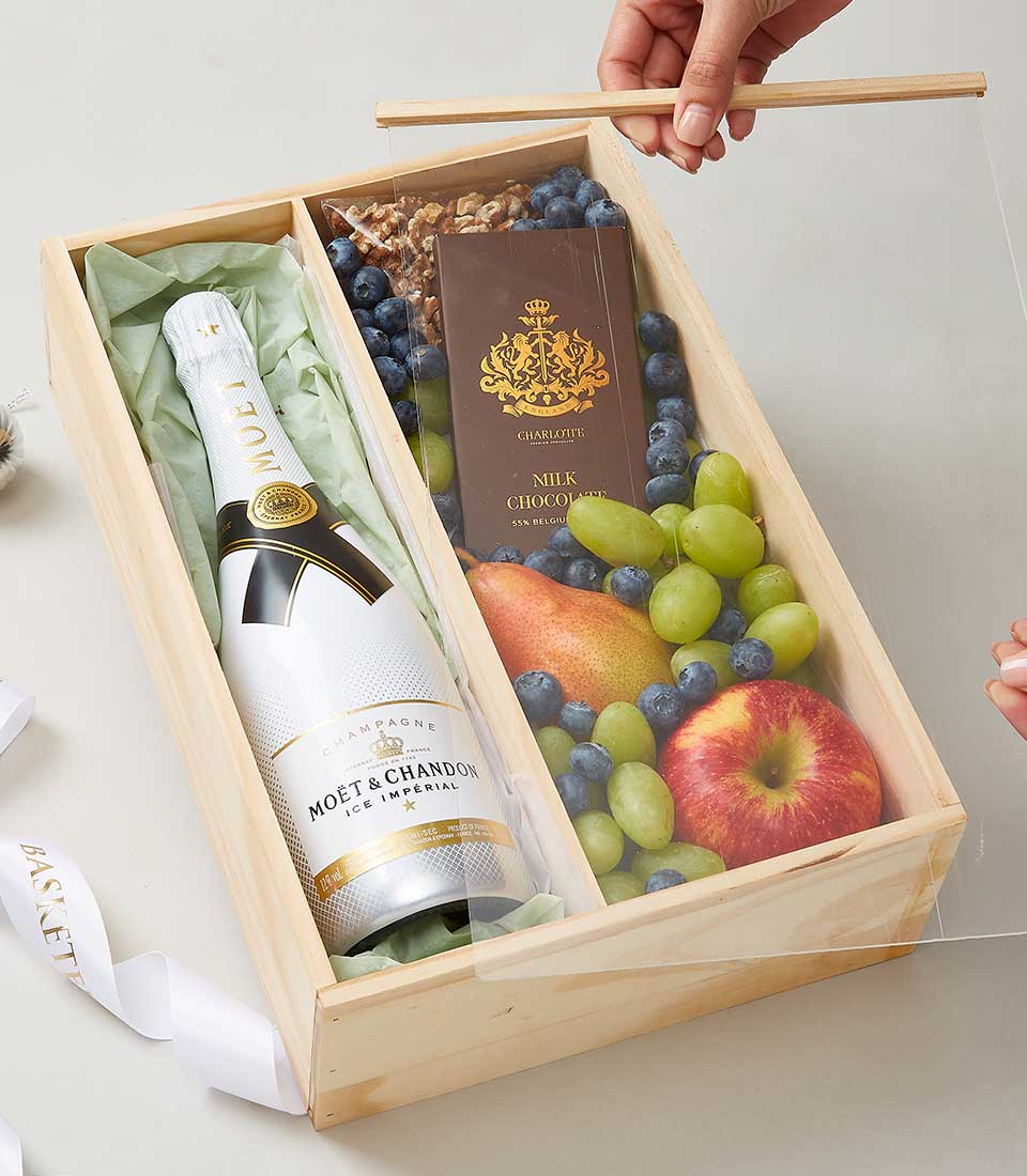 Moët & Chandon champagne gift hamper with fresh fruits, nuts, and chocolate in wooden box