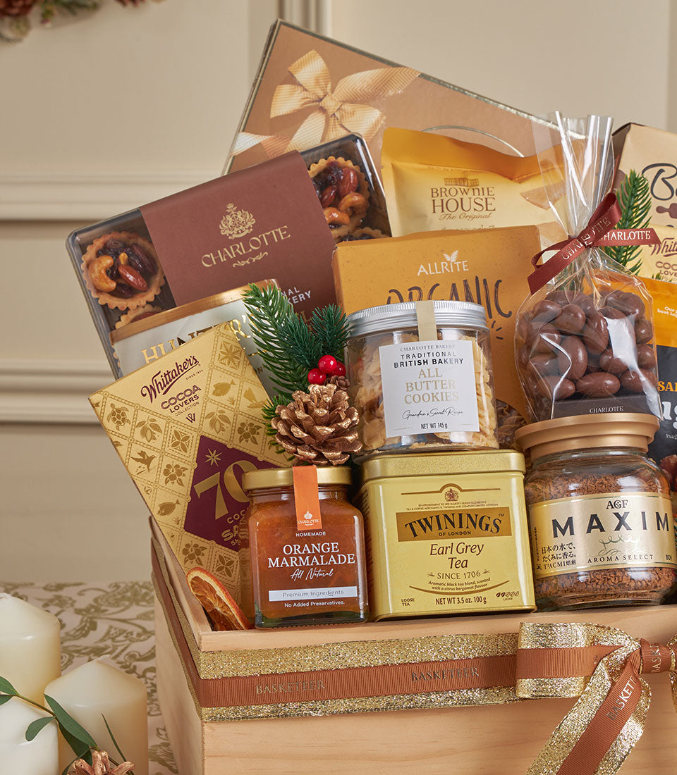 Wooden luxury gift hamper with gourmet cookies, Earl Grey tea, and marmalade, tied with gold ribbon for New Year gifting