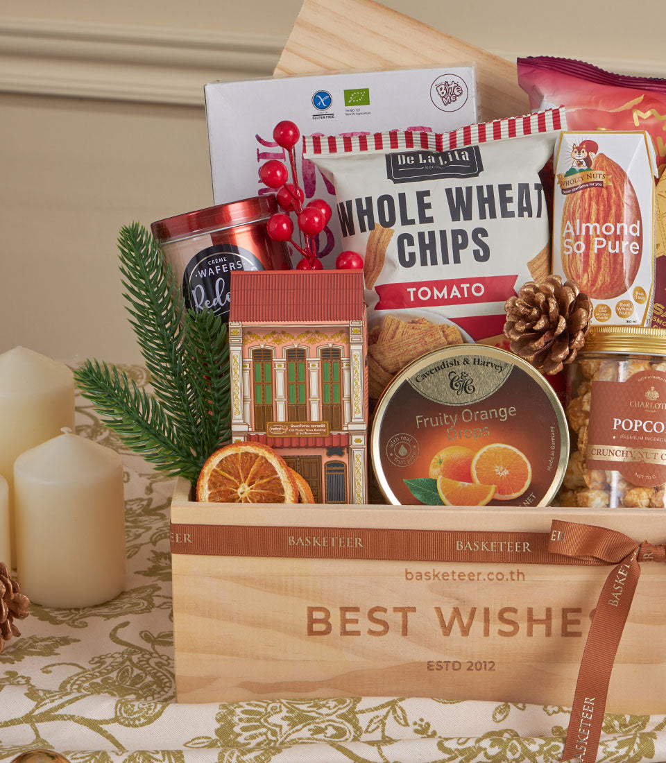 Premium healthy snack and chocolate gift basket with whole wheat chips, almonds, and festive decorations for New Year gifting