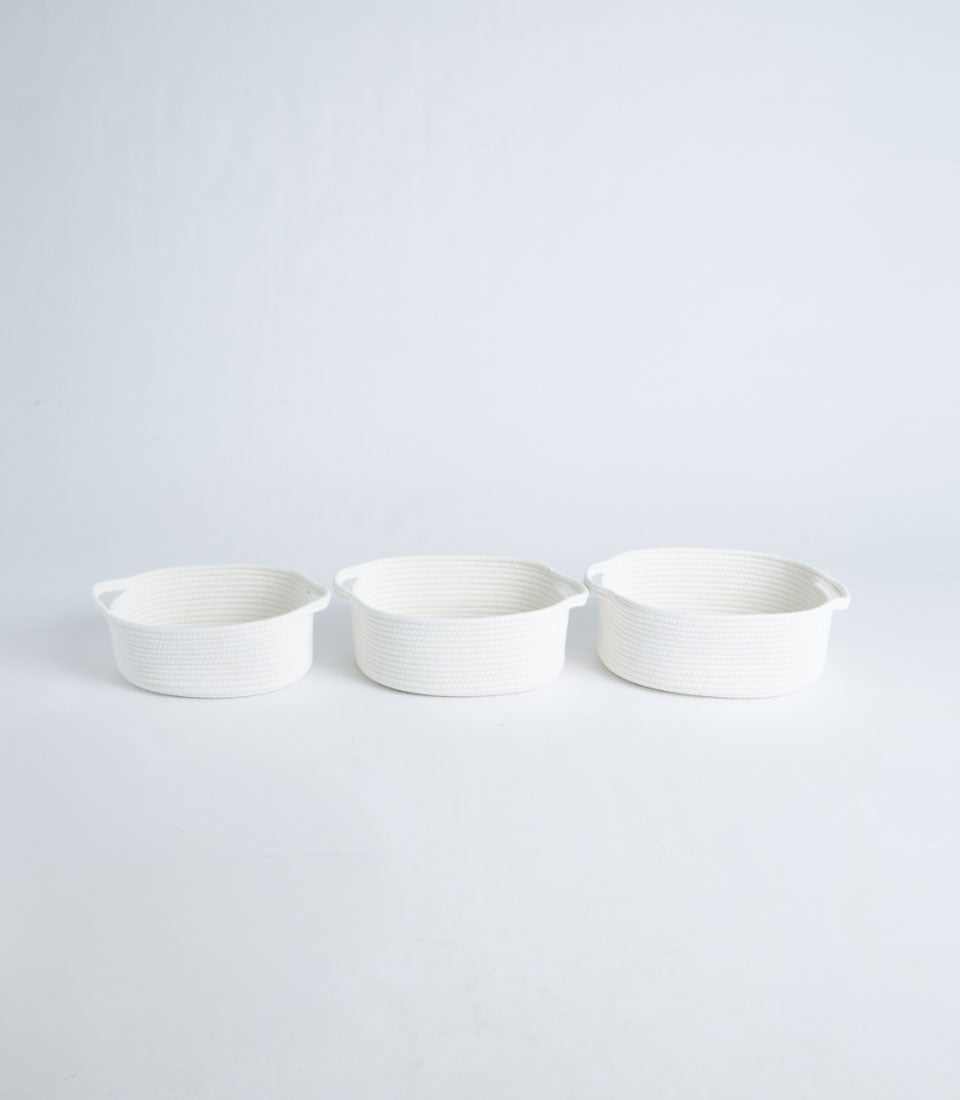 Set of three white woven cotton rope storage baskets with handles, graduated sizes for organizing