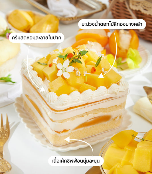 Mini mango chiffon cake with fresh cream, diced mango topping, and edible flowers in clear container