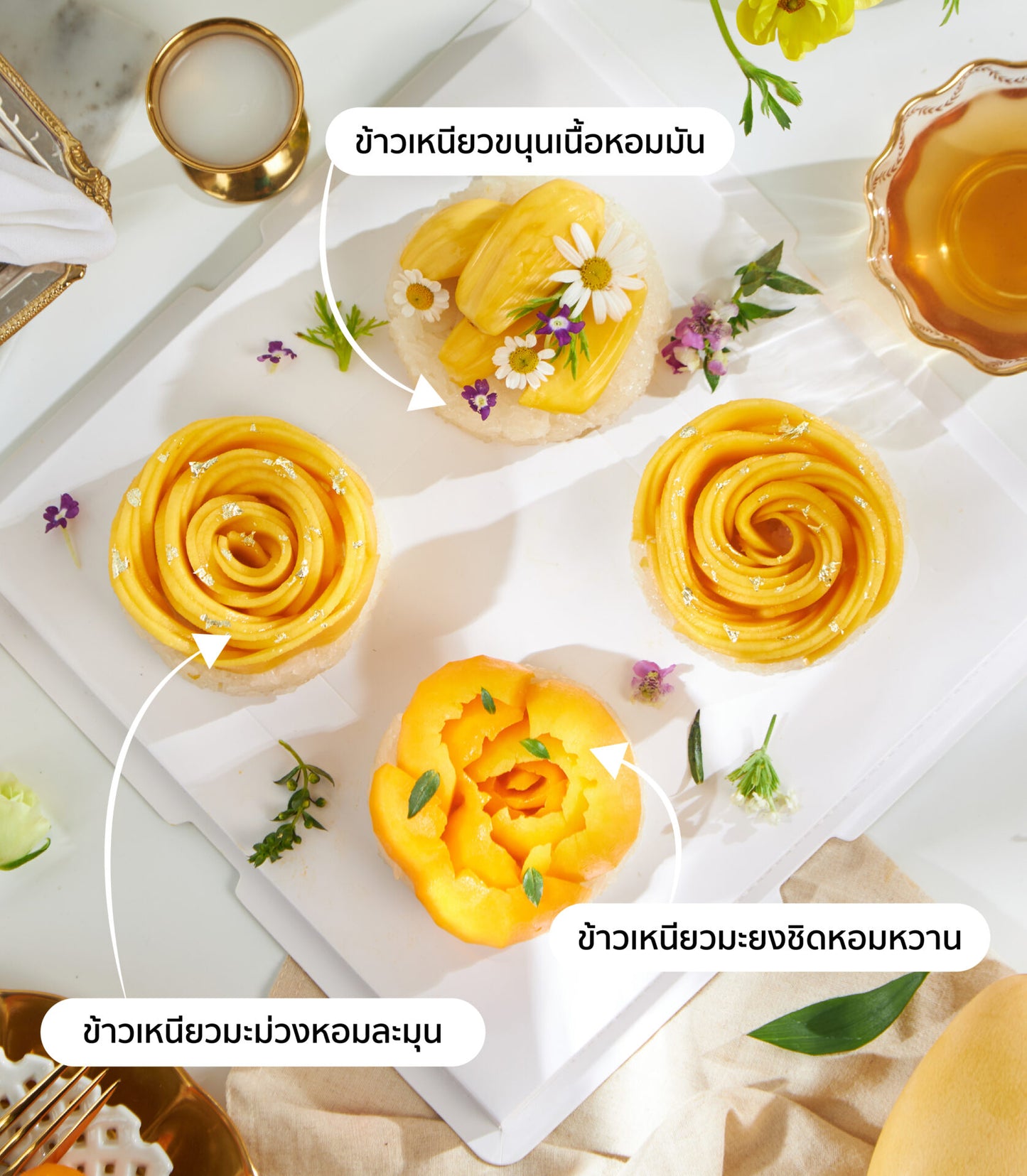 Royal Trio Thai sticky rice desserts with mango, jackfruit, and edible flowers on elegant white tray