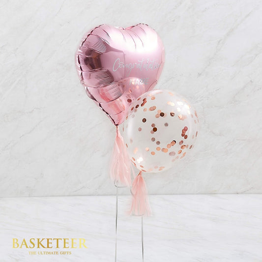 Metallic rose gold heart balloon with congratulations message and confetti-filled latex balloon, adorned with pink tassels