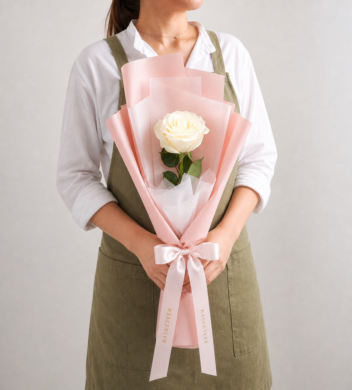 An elegant single white rose bouquet from Flowers by Basketeer, beautifully wrapped