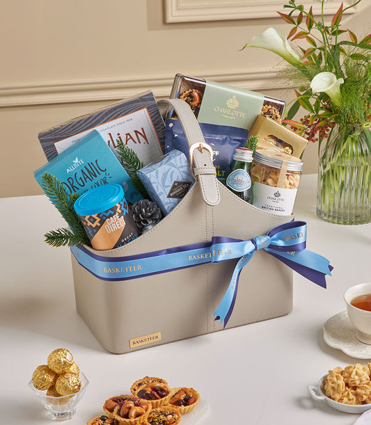 Grey faux leather gourmet tea and coffee gift basket with organic chocolates, Monsoon tea, and pine accents for New Year