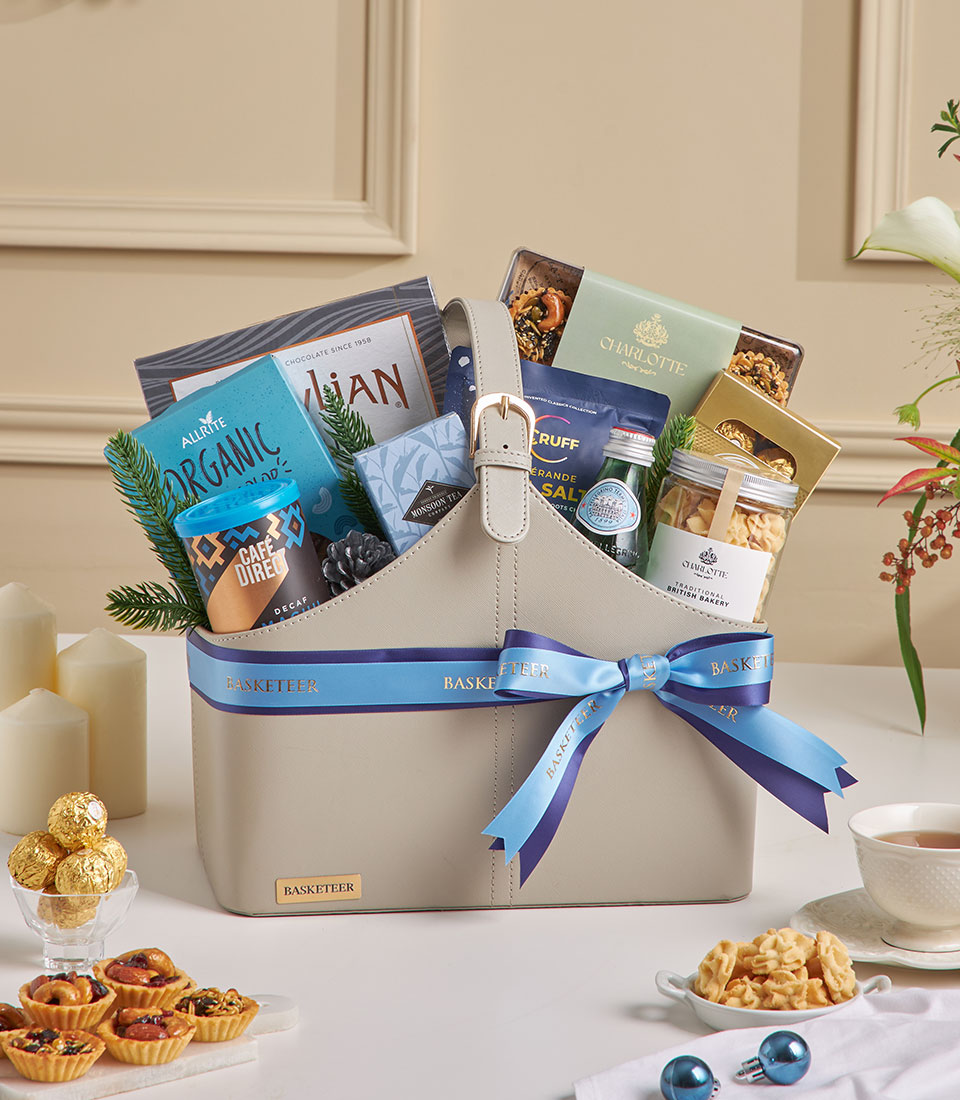 Elegant grey leather gift basket with gourmet tea, coffee, and artisan treats for New Year gifting