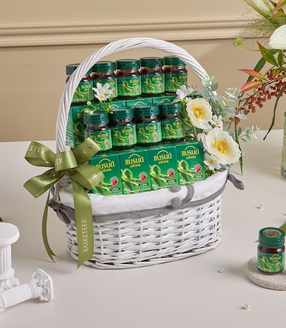 Premium chicken essence wellness basket with green supplement boxes and dark glass bottles, white woven design with green