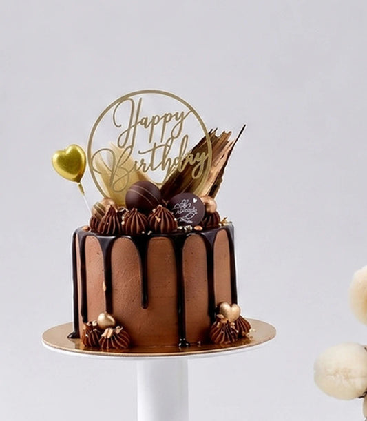 Basketeer's luxurious chocolate birthday cake with decadent drizzles, elegant gold
