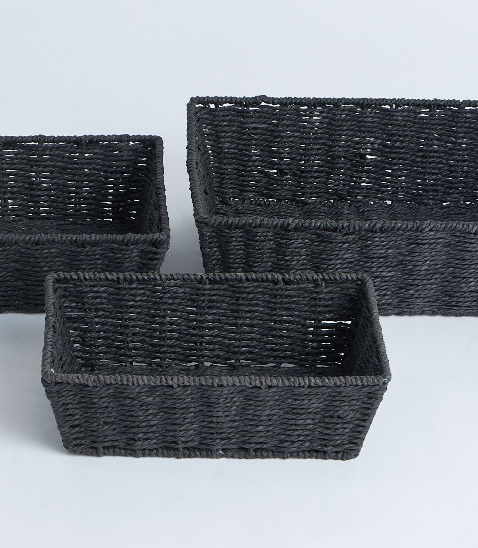 Dark woven rectangular storage baskets in three sizes, natural fiber seagrass construction with reinforced rims