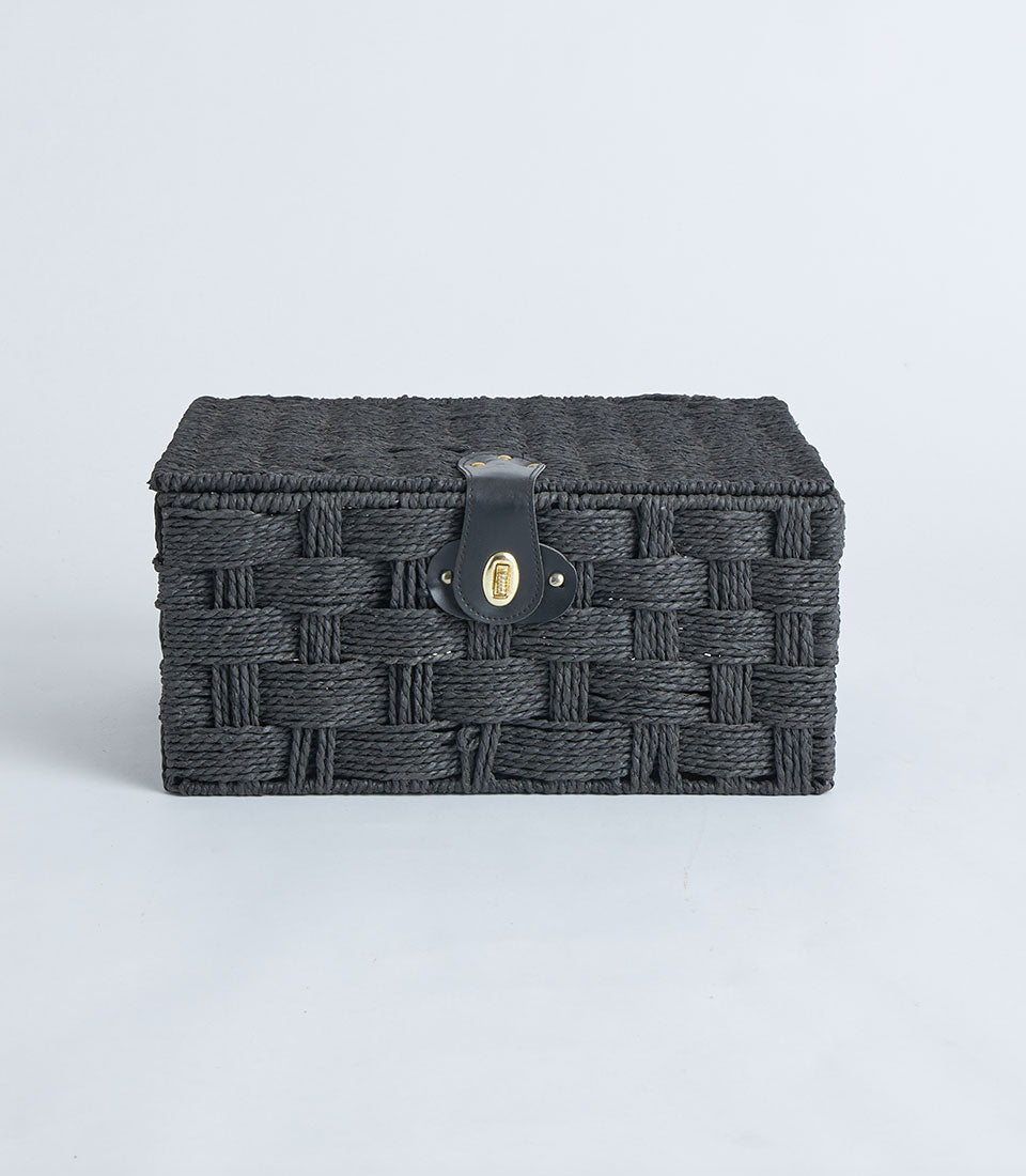 Rectangular black woven storage basket with leather lock and gold clasp
