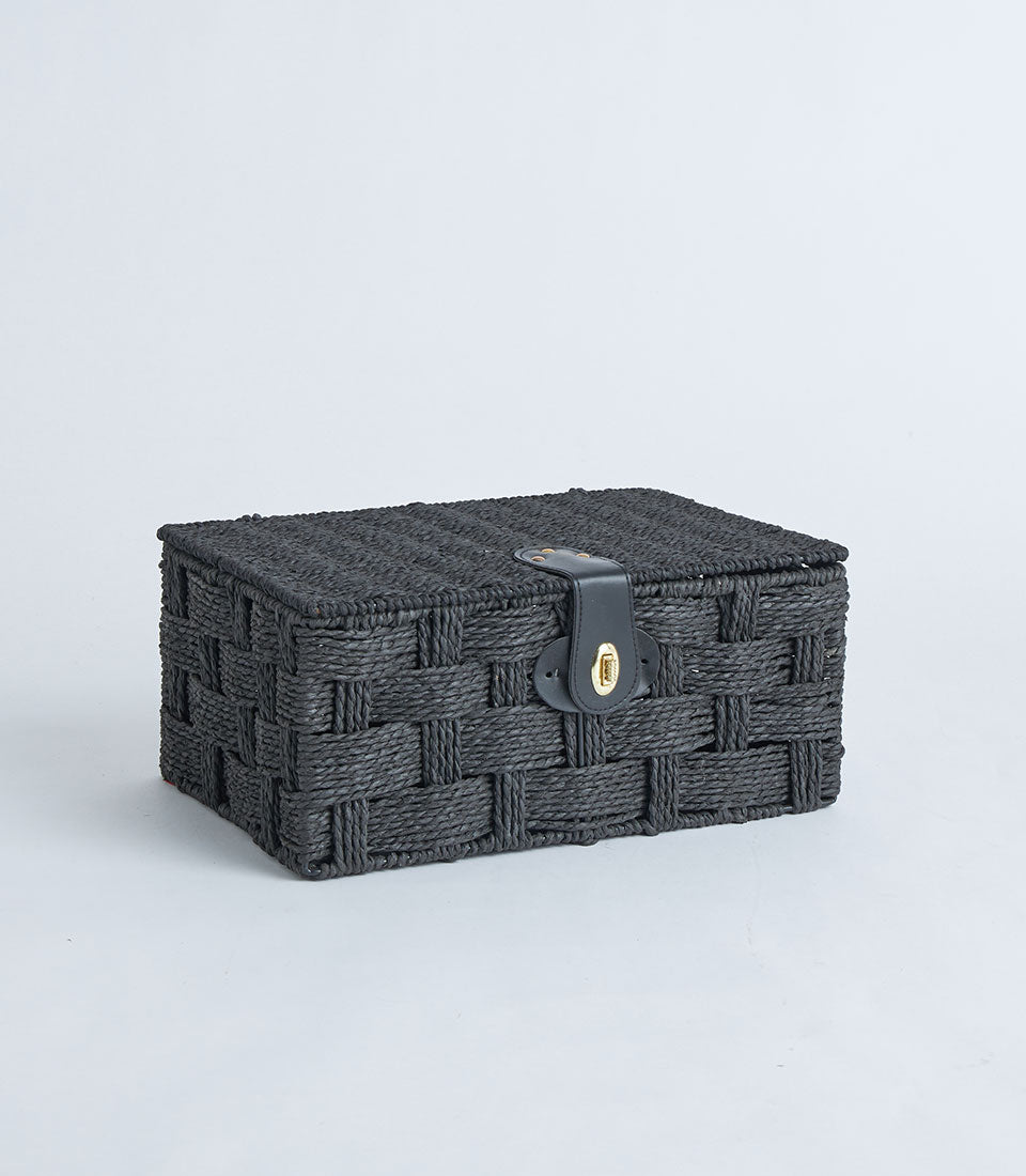 Black woven storage basket with leather lock closure and gold clasp