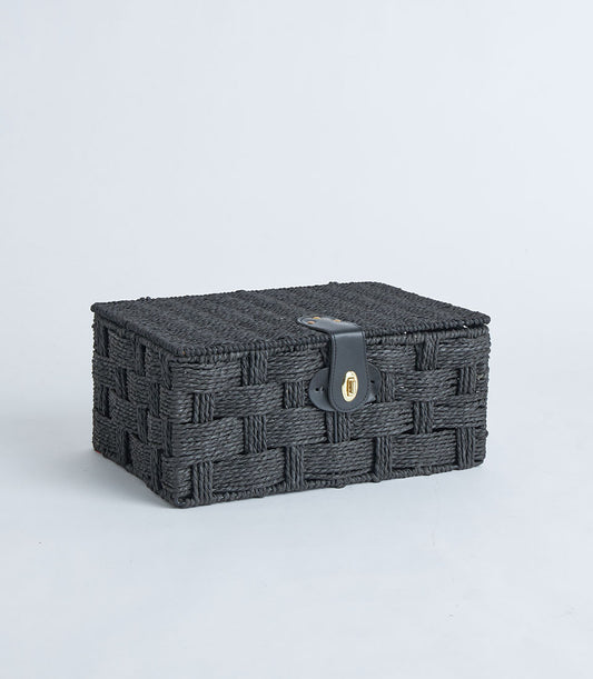 Black woven storage basket with leather lock closure and gold clasp