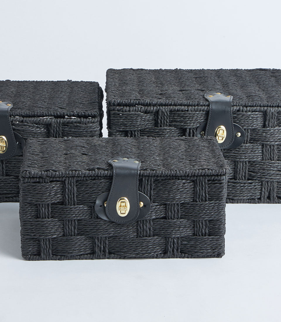 Black woven storage baskets with leather clasp, set of three graduating sizes