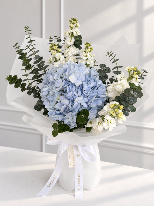 Luxurious Basketeer gift bouquet featuring a vibrant blue hydrangea, elegant white