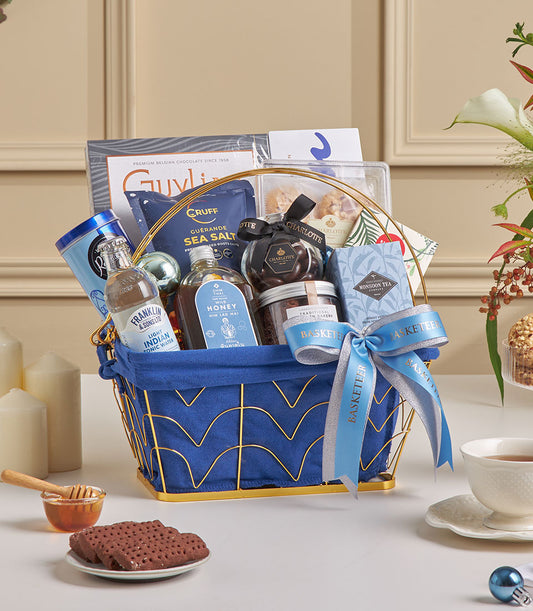 Midnight blue luxury gift hamper with Belgian chocolate, gourmet tea, honey, and artisan treats for New Year celebrations