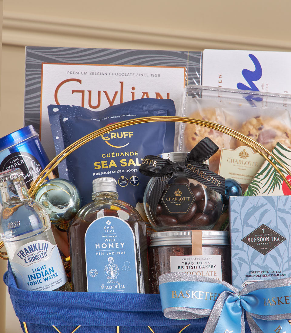 Midnight blue woven gift hamper with premium Belgian chocolate, gourmet treats, and luxury tea for New Year celebrations