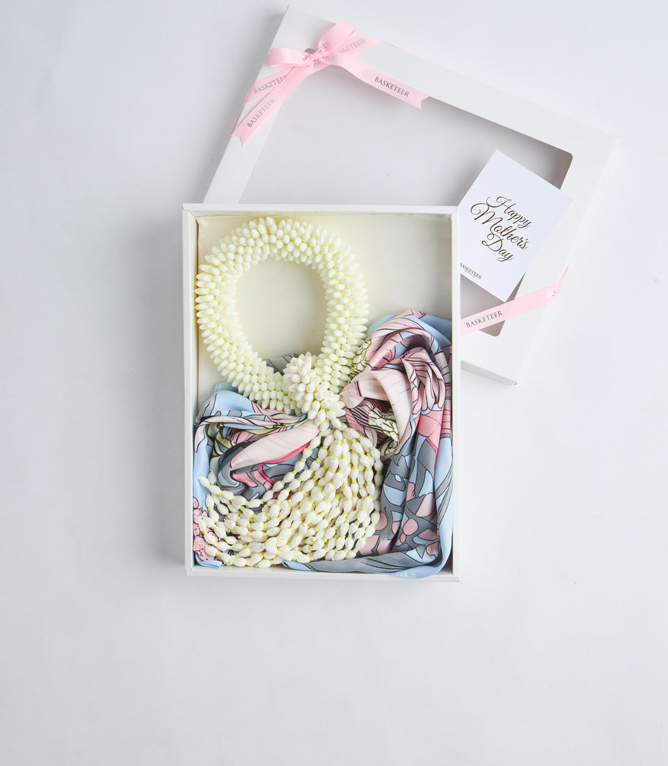 Elegant gift box containing cream pearl beaded wreath, silk scarf with floral pattern, and Happy Mother's Day card with pink ribbon bow.