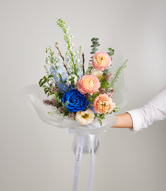 An elegant Flowers by Basketeer bouquet featuring a vibrant blue rose,