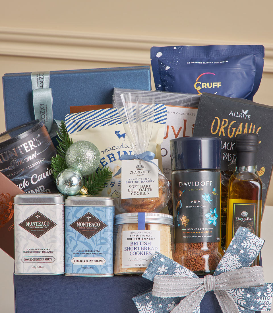 Luxury New Year gift hamper with black truffle, premium teas, gourmet cookies, and caviar in elegant dark blue box