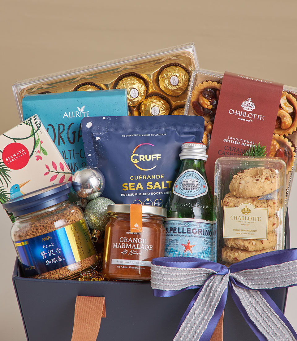 Golden luxury chocolate and coffee gourmet gift basket with artisan baked goods and sea salt treats, tied with blue ribbon