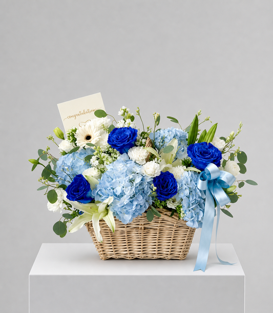 Elegant basket arrangement from Flowers by Basketeer featuring premium blue roses, light