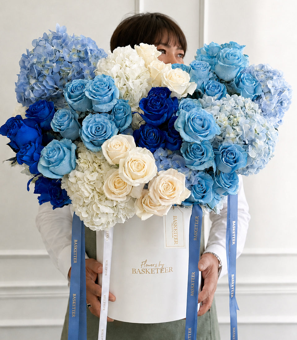 Blue and white rose and hydrangea arrangement in a premium leather flower box