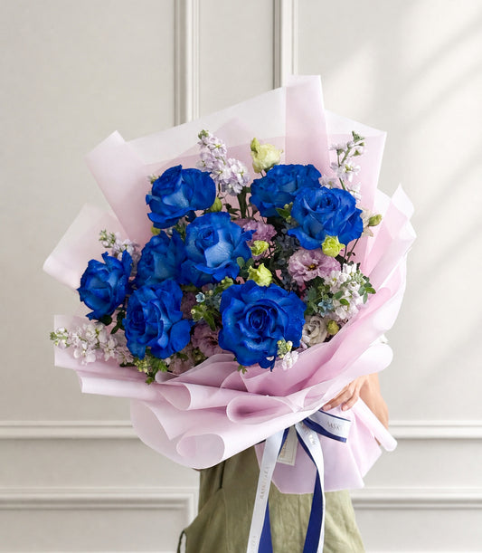 Basketeer luxury flower gift with vibrant royal blue roses and pastel