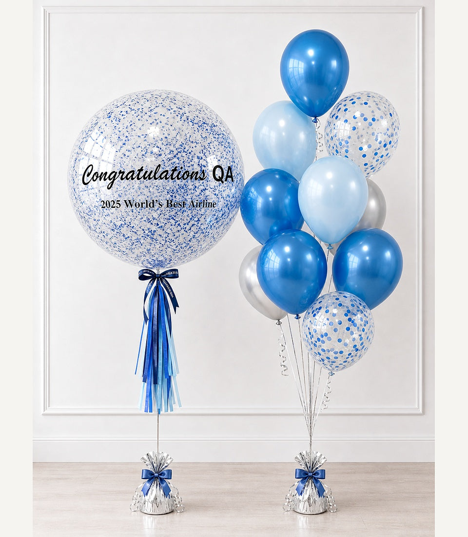Blue and white confetti-filled balloon with "Congratulations QA" text and matching blue metallic balloon bouquet with blue ribbon weights.