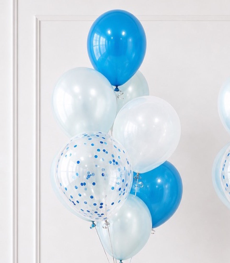 Blue and white latex balloons with confetti-filled balloon cluster against white wall background.