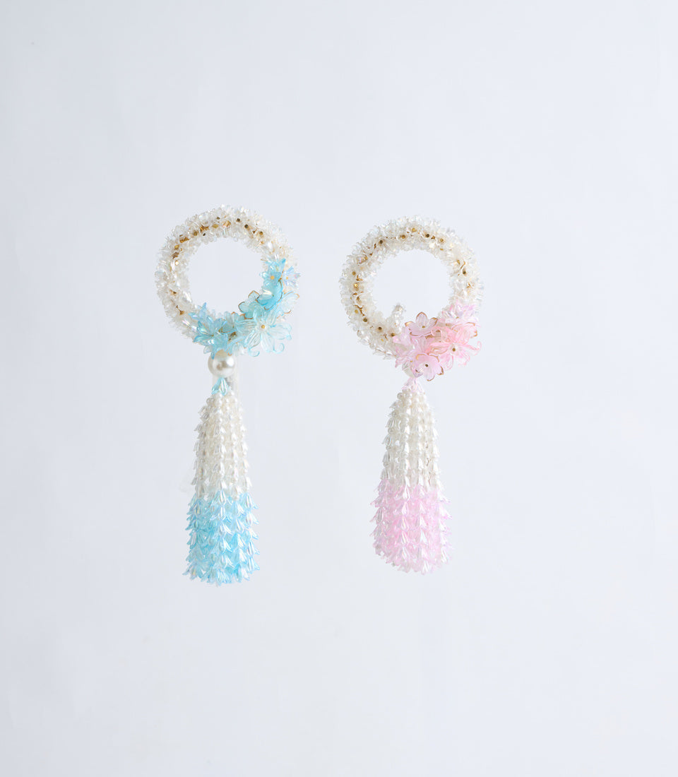 Two beaded tassel ornaments with pearl loops and flower accents in turquoise and pink, featuring delicate beadwork in white and pastel colors.
