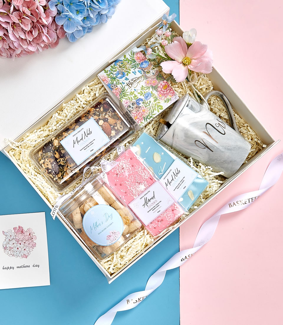 Luxury Mother's Day gift basket with gourmet nuts, artisan cookies, marble mug, and floral notebook