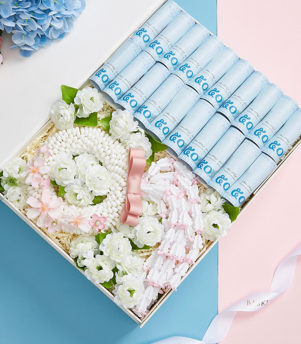 Luxury Mother's Day gift basket with white floral garlands, rolled silk scarves, and artisan presentation