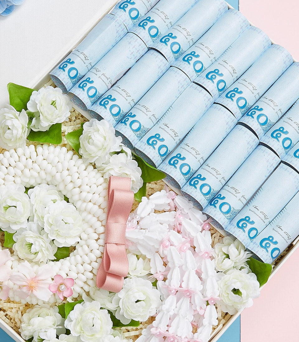 Mother's Day luxury gift basket with white floral garland, pink satin bow, and premium rolled certificates on shredded paper