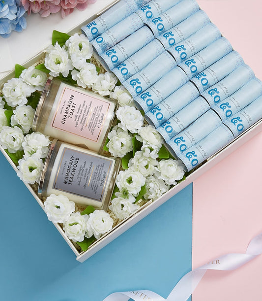 Luxury Mother's Day gift basket with champagne and teakwood candles, white flowers, and premium spa aromatics