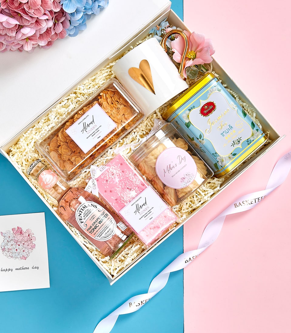 Mother's Day gift set with tea, cookies, tonic water, and gold-heart mug in white box