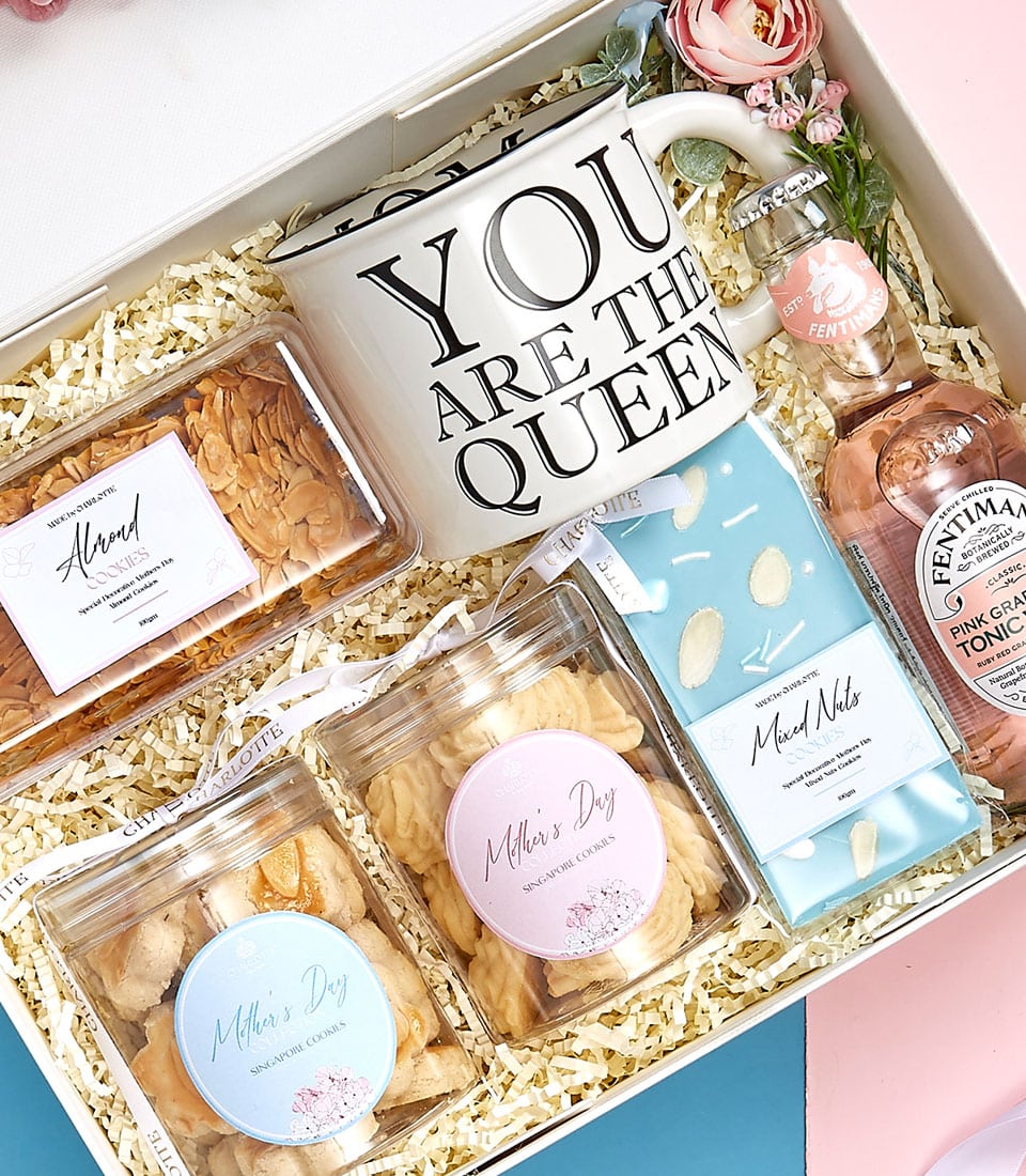 Mother's Day gift set with ceramic mug, gourmet cookies, nuts, and pink grapefruit tonic in white presentation box