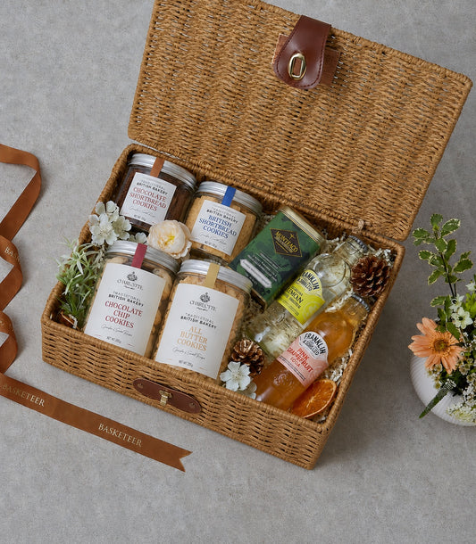 Basketeer luxury picnic hamper with a woven wicker basket filled with premium cookies