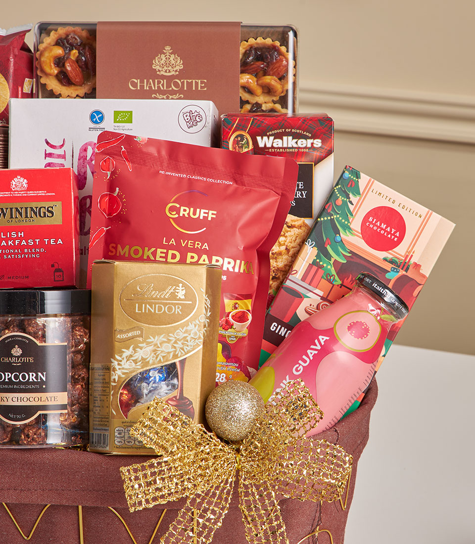 Premium gourmet hamper with Charlotte bakery tarts, Lindt chocolates, Twinings tea, and artisan snacks in gold-trimmed gift